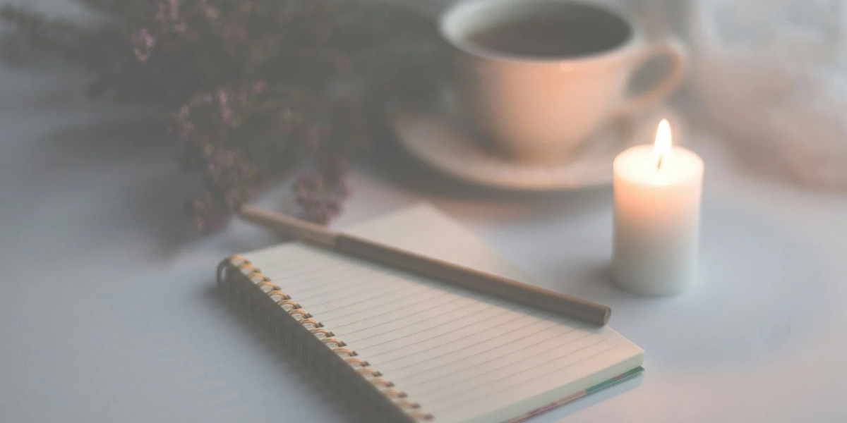 Notebooks and journals by candlelight with a cup of tea.